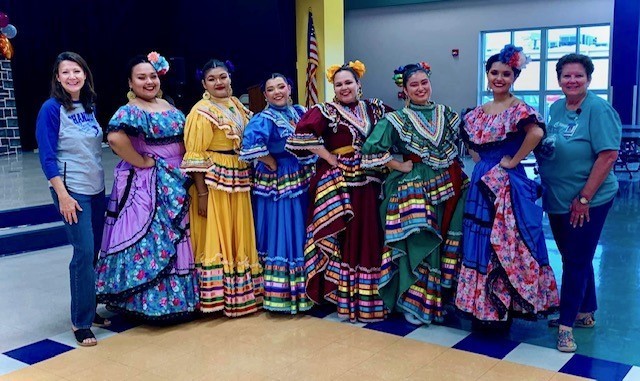 Mrs. Steed and Mrs. Schuelke posing with the Ballet Folklorico.