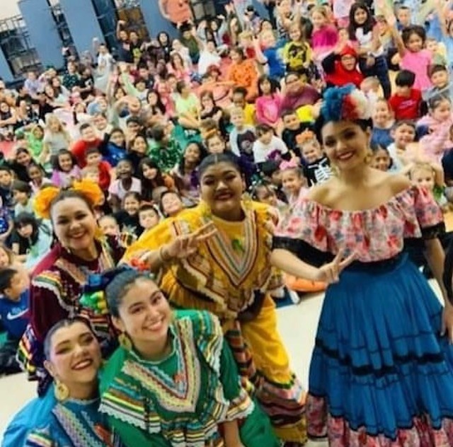 The Ballet Folklorico posing for a group picture with the students.